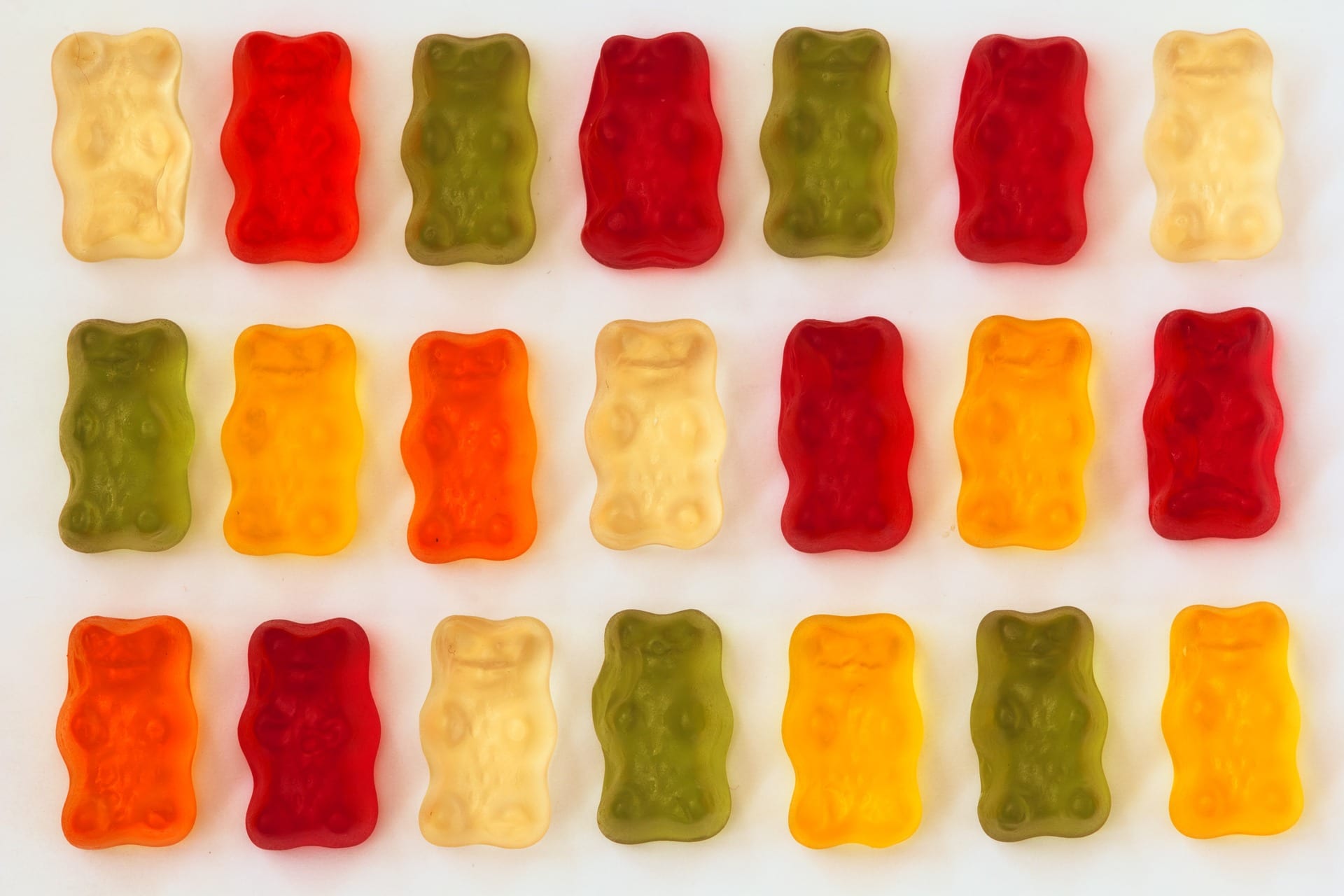 CBD in food products: gummy sweets lined up in green, red, white and orange colours.